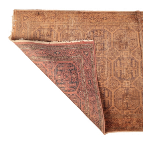 61 - A BOKHARA RUG

with a brick red field containing three rows of guhls within multiple foliate borders... 