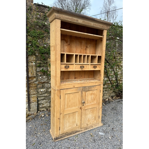 469 - A PINE DRESSER

20th century, the upper section with moulded cornice over shelves, plate dividers, a... 