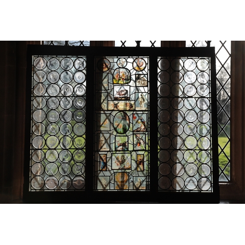 65 - A LEADED LIGHT WINDOW in three sections, the central panel incorporating stained glass panels of goa... 