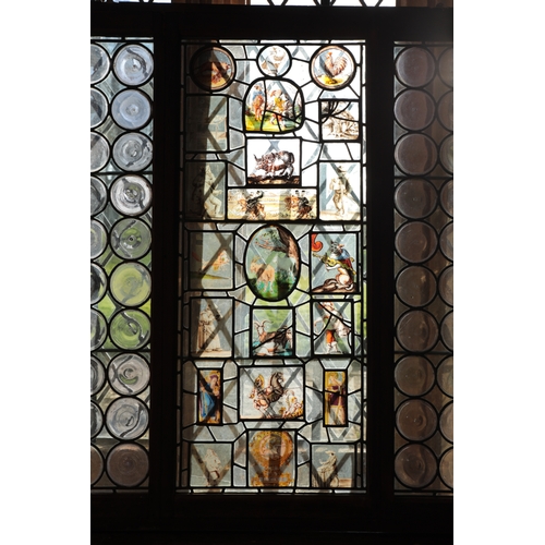 65 - A LEADED LIGHT WINDOW in three sections, the central panel incorporating stained glass panels of goa... 