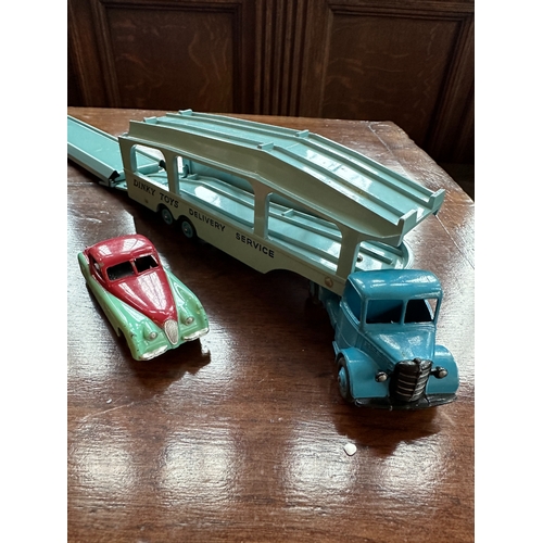 422a - A DINKY SUPERTOYS PULLMORE CAR TRANSPORTER boxed; two Dinky Supertoys army wagons; a Dinky Supertoys... 