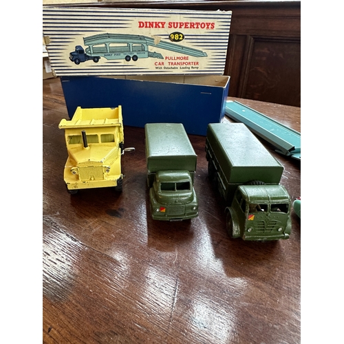 422a - A DINKY SUPERTOYS PULLMORE CAR TRANSPORTER boxed; two Dinky Supertoys army wagons; a Dinky Supertoys... 