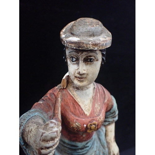 145 - A POLYCHROME PAINTED WOODEN FIGURE OF A FARM GIRL 37cm high (damage to pick)