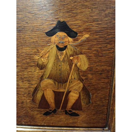 150 - AN OAK SMOKER'S CABINET, IN THE MANNER OF SHAPLAND & PETTER with a marquetry panel depicting an 18th... 