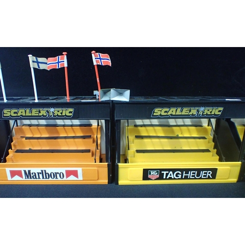 203 - 4 VINTAGE SCALEXTRIC GRANDSTANDS 2 Tag Heuer, 1 Castrol GTX and 1 Marlboro. 1 with seated figures an... 