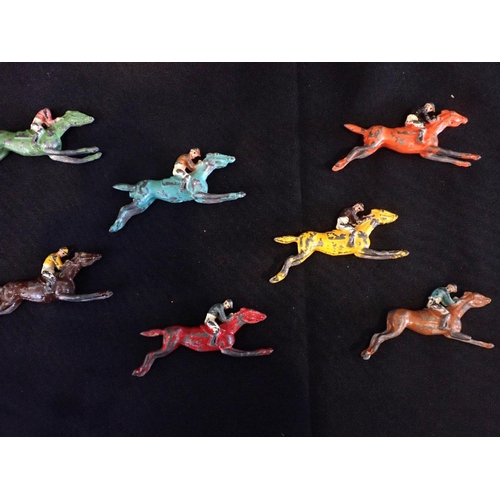 247 - SEVEN CHAD VALLEY PAINTED LEAD RACEHORSES (all playworn, some with damage) contained in an old Chees... 