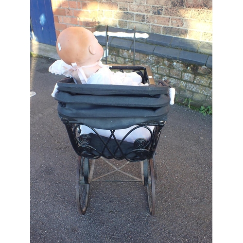 262 - A VICTORIAN STYLE DOLL'S PRAM, AN A M GERMANY BISQUE HEAD DOLL 351/8K, 48cm high, and a smaller plas... 