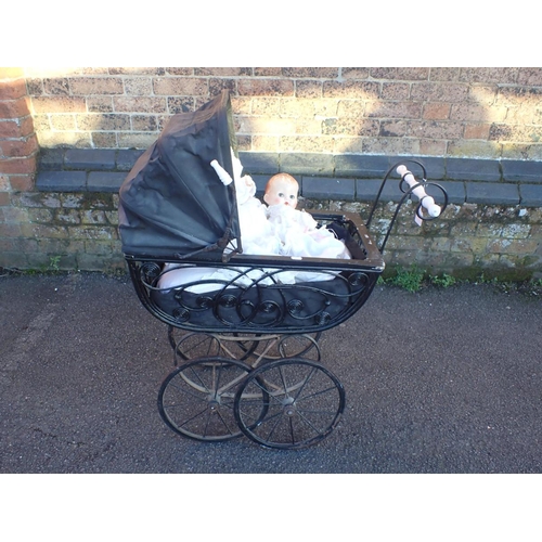 262 - A VICTORIAN STYLE DOLL'S PRAM, AN A M GERMANY BISQUE HEAD DOLL 351/8K, 48cm high, and a smaller plas... 