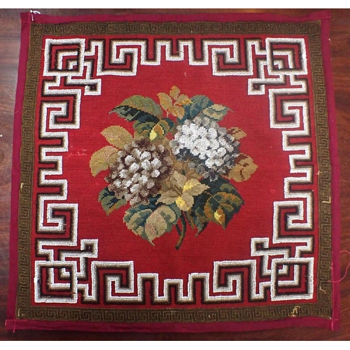 299 - A 19TH CENTURY BEADED WOOL WORK PANEL with central flower motif with Greek key border 46 x 46cm (sma... 