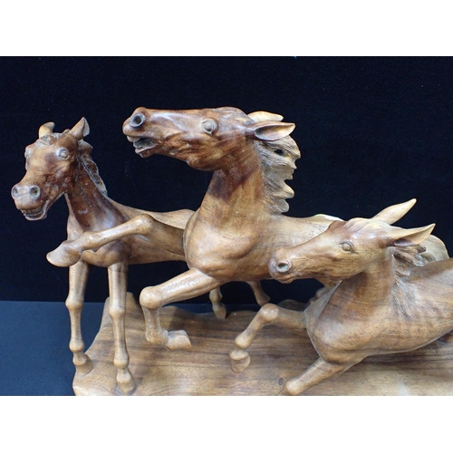 30 - A CARVED HARDWOOD HORSE SCULPTURE 66cm long, and other wood carvings