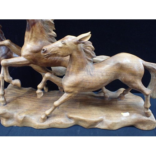 30 - A CARVED HARDWOOD HORSE SCULPTURE 66cm long, and other wood carvings