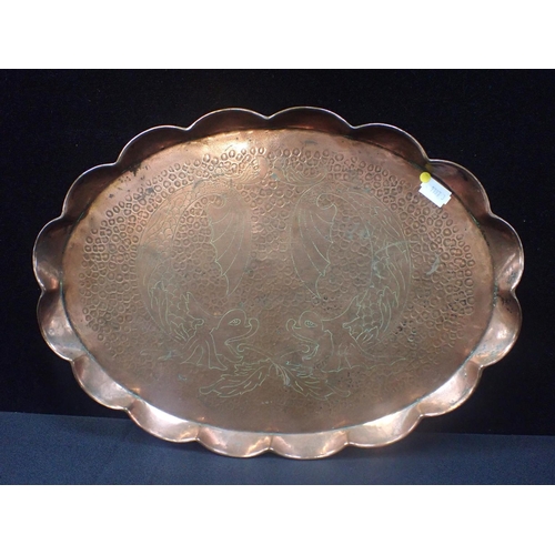 303 - AN ARTS AND CRAFTS NEWLYN STYLE COPPER TRAY with incised dolphins on an embossed ground, with lobed ... 