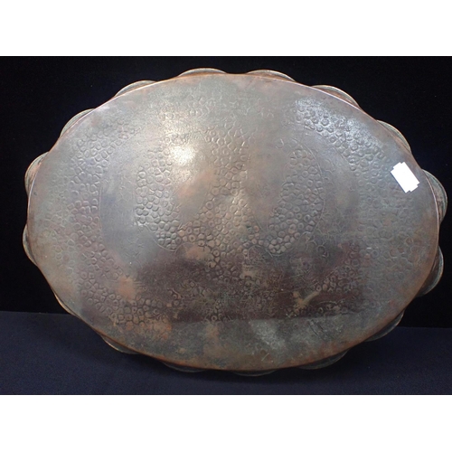 303 - AN ARTS AND CRAFTS NEWLYN STYLE COPPER TRAY with incised dolphins on an embossed ground, with lobed ... 