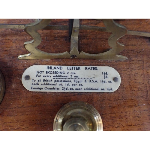 313 - A POSTAL SCALE WITH BRASS WEIGHTS and ivorine Rates plaque