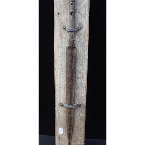 321 - AN AFRICAN SPEARHEAD on a stained wood mount, inscribed 'NORTH AFRICAN SPEAR 1890', with an indistin... 