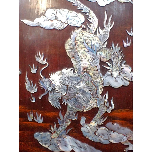 410 - A FAR EASTERN HARDWOOD PANEL inlaid with a dragon in mother of pearl, 60 cms high