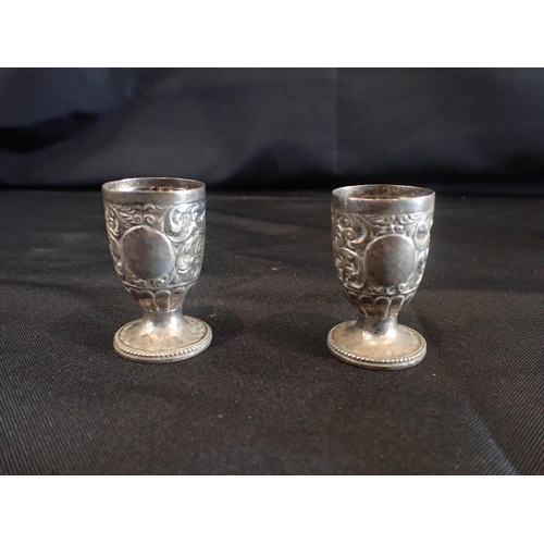 442 - A PAIR OF SILVER QUAIL EGG CUPS, BY CHARLES STUART HARRIS London 1886, with repousse decoration, and... 