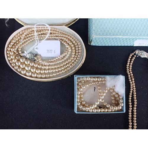 512 - THREE VINTAGE FAUX PEARL NECKLACES including a two-row graduated with paste-set clasp and spacers; a... 