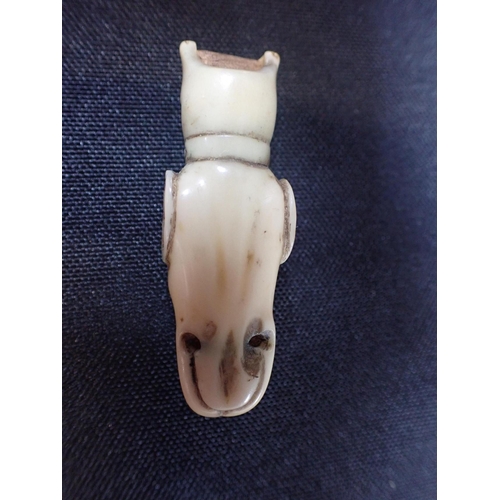 547 - A CARVED BONE WHISTLE, IN THE FORM OF A DOG'S HEAD 5.5cm long