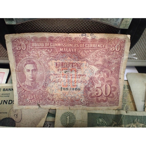 560 - A QUANTITY OF MIXED COINS AND BANKNOTES including George VI Malaya Fifty Cents, in a grey case