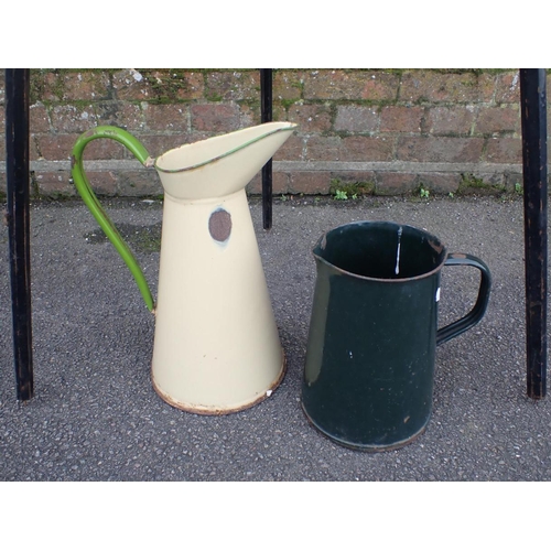 67 - TWO LARGE OLD ENAMEL JUGS and a vintage ebonised camera tripod (3)