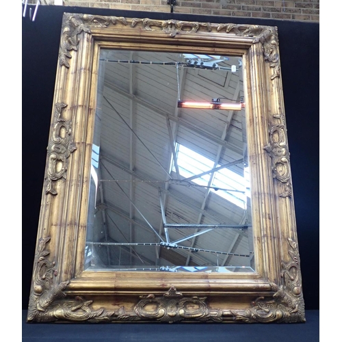 776 - A MOULDED AND GILT FRAMED WALL MIRROR with bevelled plate 77 x 102cm