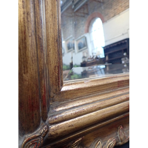 776 - A MOULDED AND GILT FRAMED WALL MIRROR with bevelled plate 77 x 102cm