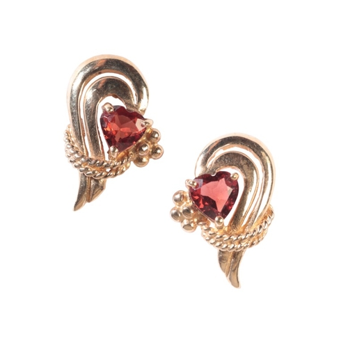 190 - A PAIR OF STYLISED HEART EARRINGS

in 9ct gold, each set with a heart shape garnet held in claw sett... 