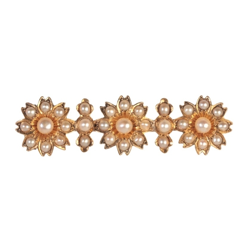 196 - AN ANTIQUE FLOWER BAR BROOCH

in 15ct gold, designed as three flowers set throughout with seed pearl... 