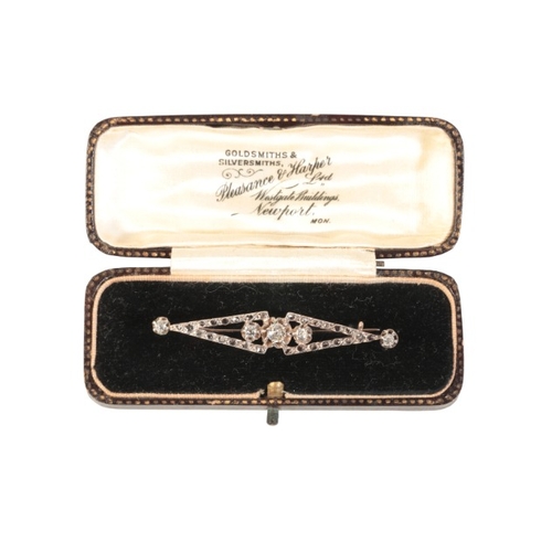 210 - AN ANTIQUE DIAMOND BROOCH

in silver on 9ct gold, of stylised design, set with three principal old m... 