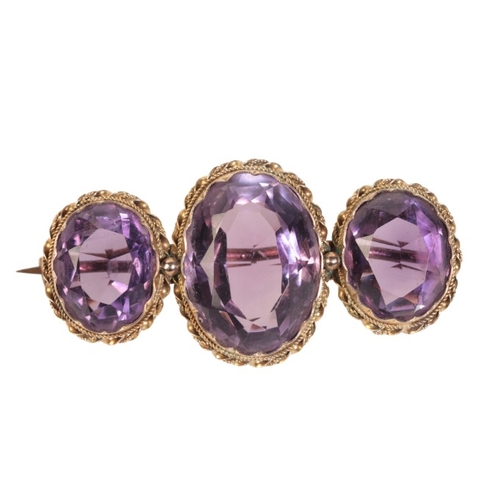 211 - AN ANTIQUE AMETHYST BROOCH

in 9ct gold, set with three oval cut amethysts held in collet settings, ... 