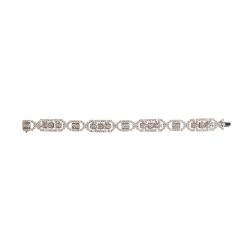 230 - A 6.96 CARAT DIAMOND BRACELET

in 18ct white gold, comprising a series of geometric openwork panels ... 