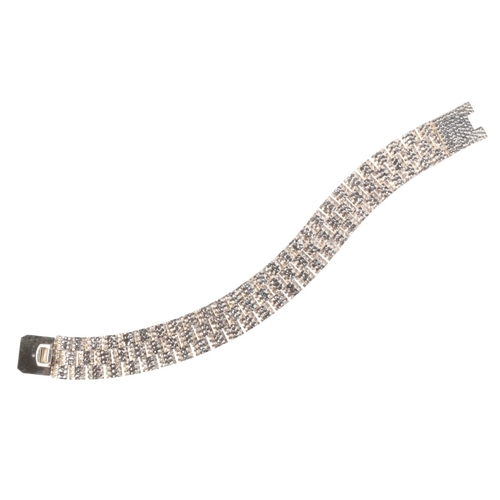232 - A STYLISED CHAIN LINK BRACELET

in sterling silver, formed of three rows of domed links with hammere... 