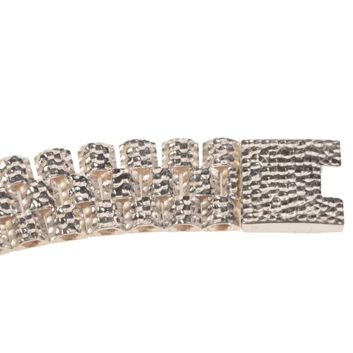 232 - A STYLISED CHAIN LINK BRACELET

in sterling silver, formed of three rows of domed links with hammere... 