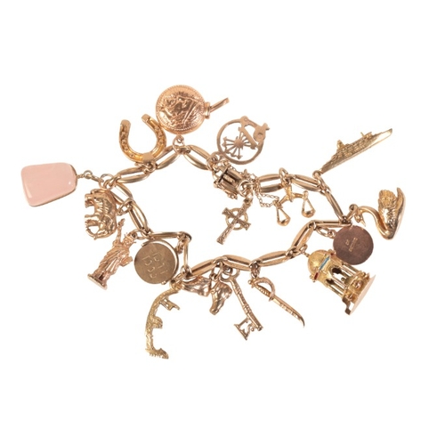 234 - A VINTAGE CHARM BRACELET

in 9ct gold, comprising a fancy link bracelet suspending sixteen charms, s... 
