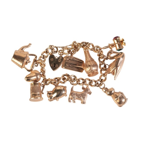 238 - A VINTAGE CHARM BRACELET

in 9ct gold, comprising a curb link chain bracelet, each link individually... 