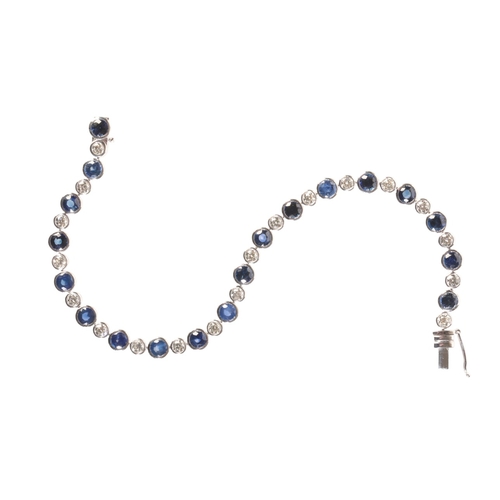 239 - A SAPPHIRE AND DIAMOND LINE BRACELET

in platinum, comprising a row of alternating round cut sapphir... 