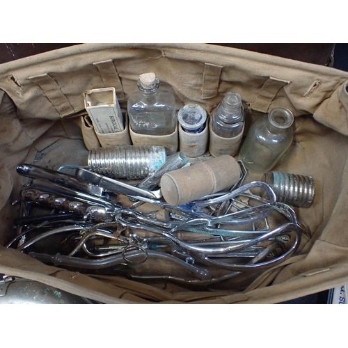 124 - AN OLD LEATHER DOCTOR'S BAG and a variety of medical instruments