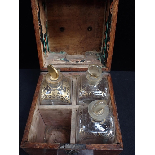 317 - A SET OF FOUR GILDED GLASS DECANTERS, IN AN OAK CASE early 19th century (case a/f, gilt worn)