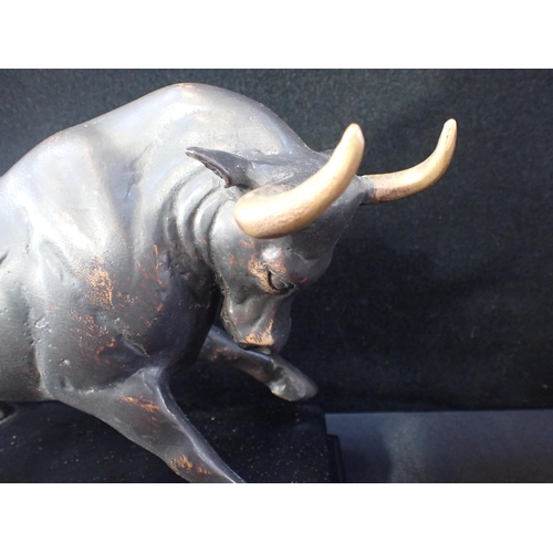 34 - A PATINATED BRONZE STUDY OF A CHARGING BULL (hollow) on an ebonised base 32cm wide, and a cast round... 