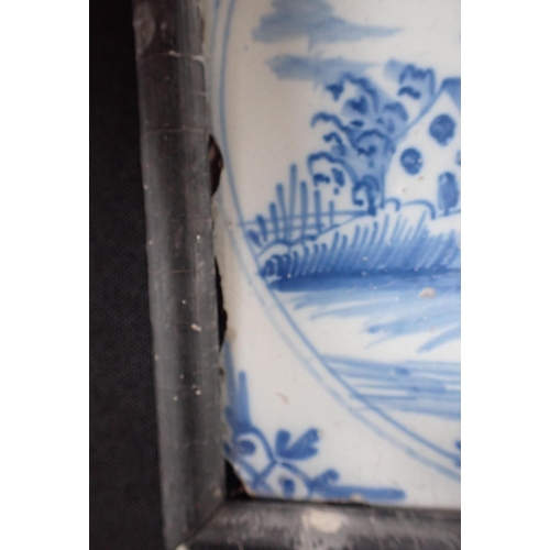 392 - A PAIR OF EARLY 19TH CENTURY BLUE AND WHITE KNIFE RESTS and a framed Delft tile, painted with a chur... 