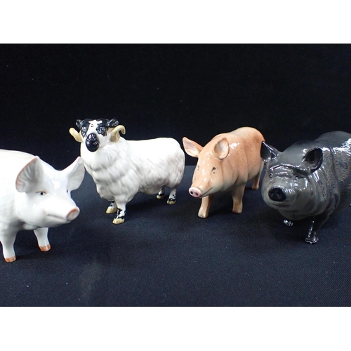 409 - TWO ROYAL DOULTON PIGS with a beswick sheep and pig (Beswick pig has a chipped ear). (4)