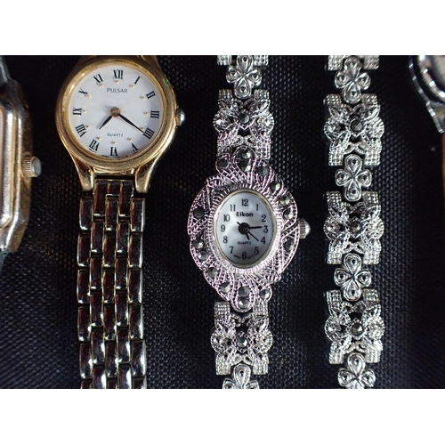 502 - A COLLECTION OF LADIES' WATCHES including an Art deco style nurse's watch, a clip watch etc