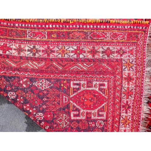 788 - A RED GROUND PERSIAN DESIGN RUG 170 x 254cm plus fringes