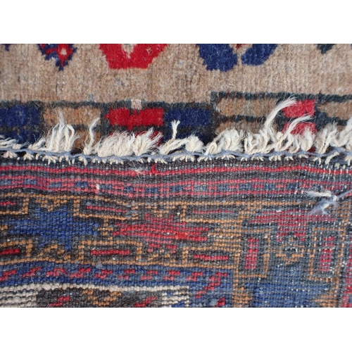 793 - A BELOUCH PRAYER RUG with architectural motifs worked in reds and blue, 83 x 160cm (moth damaged)