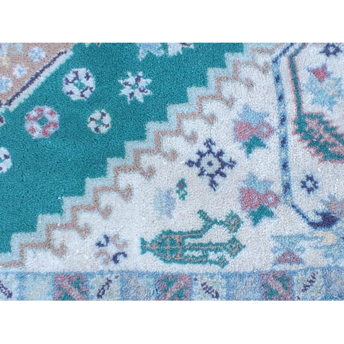 794 - A MOROCCAN RUG, IN PALE COLOURS 176 x 252cm plus fringes