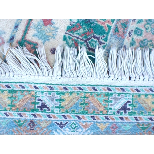 794 - A MOROCCAN RUG, IN PALE COLOURS 176 x 252cm plus fringes