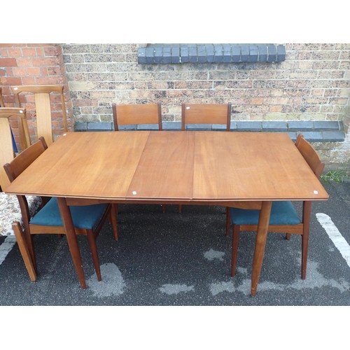 822 - A MID-CENTURY MODERN TEAK DINING TABLE AND CHAIRS the table 84 x 122cm extending to 155cm, with four... 