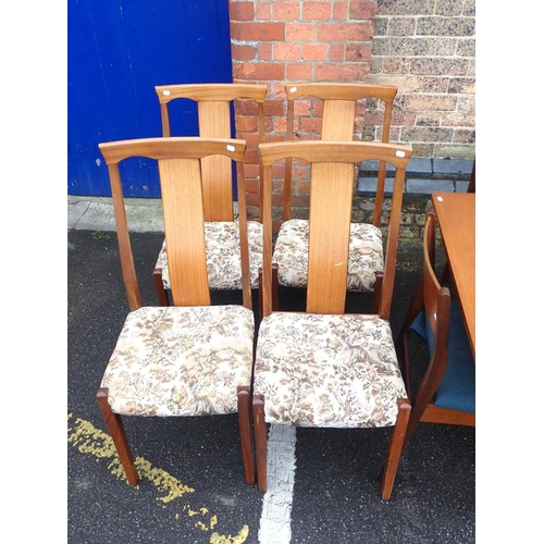 822 - A MID-CENTURY MODERN TEAK DINING TABLE AND CHAIRS the table 84 x 122cm extending to 155cm, with four... 