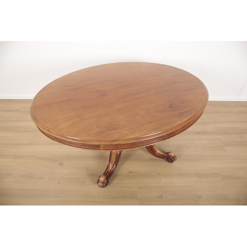 848 - A VICTORIAN MAHOGANY BREAKFAST TABLE the oval tilt top on a turned and heavily carved stem, to cabri... 